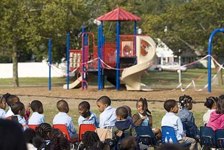 Students at J. Cresswell Stuart Elementary School wait for the dedication ceremony for their deceased principal to begin.