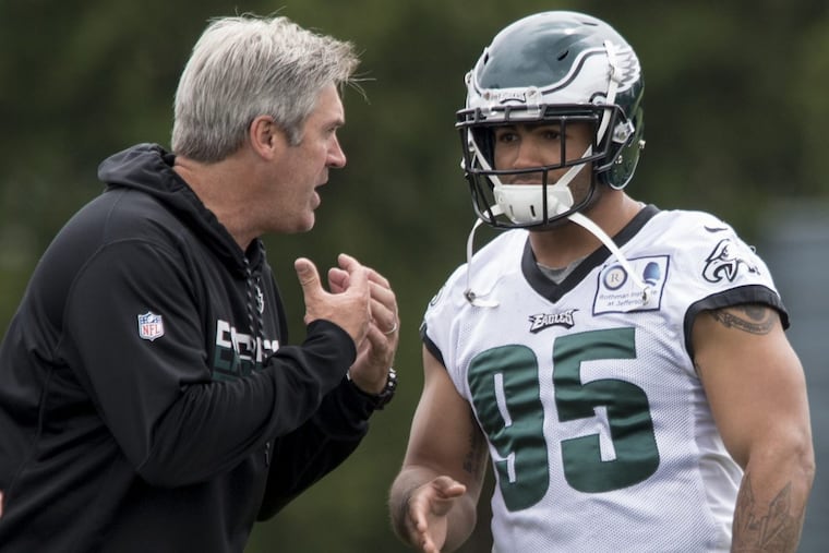 Eagles head coach Doug Pederson talks with linebacker Mychal Kendricks during OTAs May 23, 2017. CLEM MURRAY / Staff Photographer