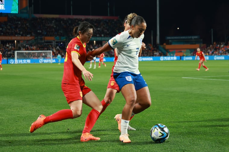 England's Lauren James (right) battles for control of the ball with China's Wu Haiyan during their World Cup Group D soccer match on Tuesday.