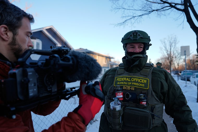 Federal Bureau of Prisons officers in Minneapolis threaten AP video journalist Mark Vancleave with arrest on Jan. 28.