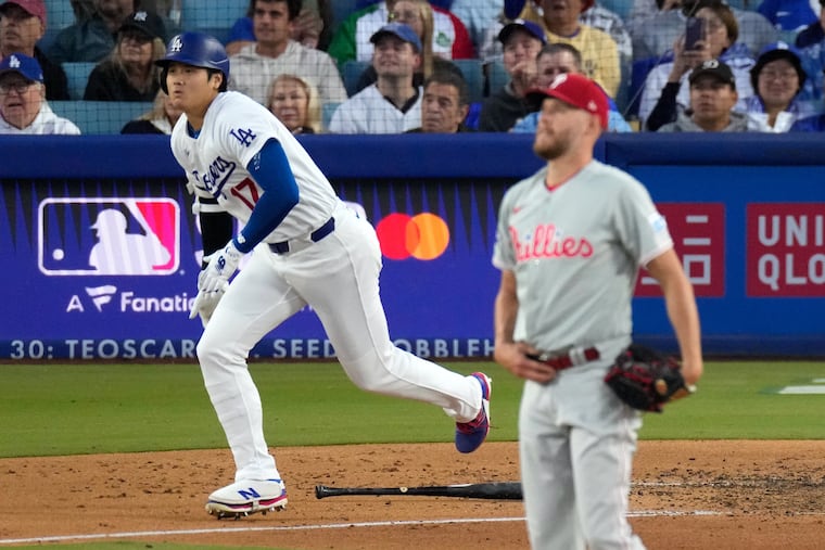 Dodgers' Shohei Ohtani (left) hit one of four solo home runs starting pitcher Zack Wheeler allowed across six innings.