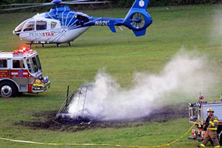 PennStar helicopter gets ready to transport a burn victim from Sunday's hot-air balloon crash. (AP Photo/Daily Local News, Tom Kelly IV)