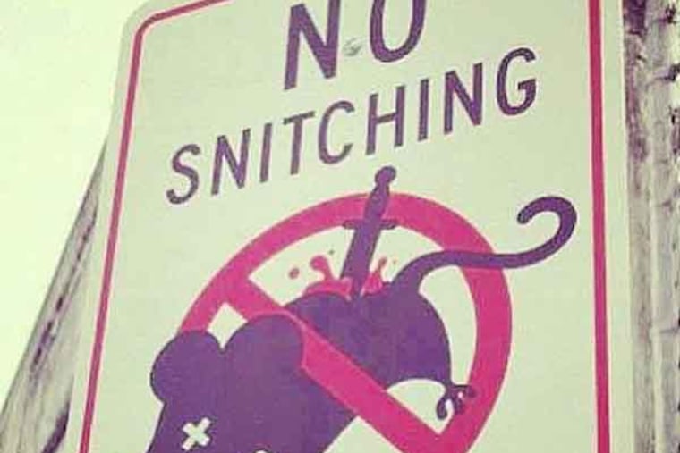 screen grab of a no snitching rat sign