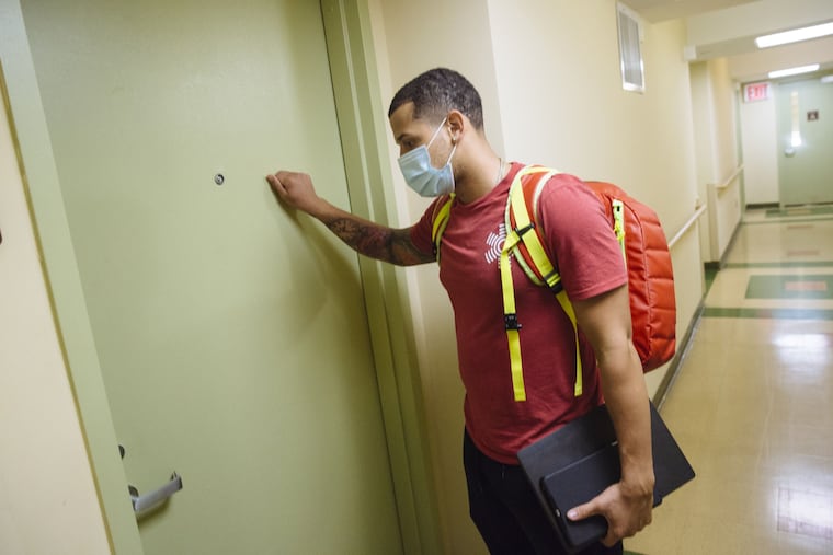 Ready paramedic Abel Collado arrives at a patient's home in the Bronx. Bloomberg photo by Angus Mordant