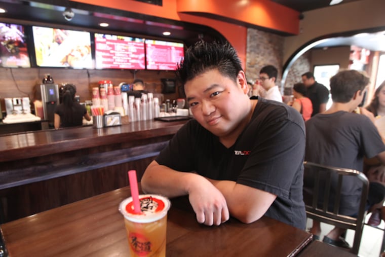 Owner Kenny Poon, with a Hong Jasmine Bubble tea drink, at his hip tea shop, Tea Do, on the northwest corner of 10th and Cherry Streets in Chinatown. 8/29/ 2013 ( MICHAEL BRYANT / Staff Photographer )