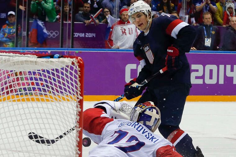 Team USA's T.J. Oshie puts one of his four shootout goals past Russia's Sergei Bobrovsky. (Associated Press)