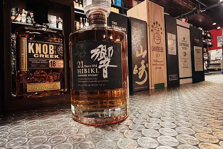 Bottles of Knob Creek and a hard-to-find Hibiki 21 years old on the bar at Hop Sing Laundromat. The Hibiki is $100 for 2 ounces.