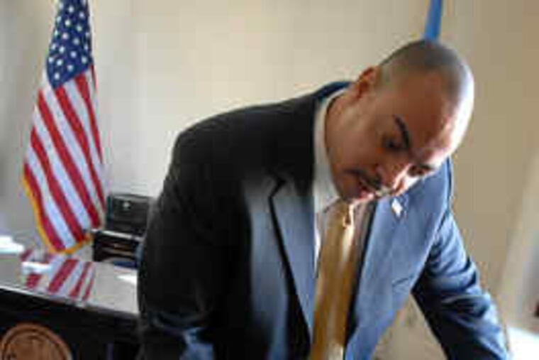 Seth Williams, Pennsylvania's first African American district attorney, with a welcoming gift: A turn-of-the-century photo of Philadelphia's first all-black police detachment.