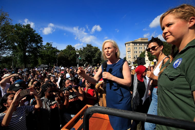 Sen. Kirsten Gillibrand, D-N.Y., with actress and comedian Amy Schumer, right, and actress model Emily Ratajkowski, center, speaks at a rally against then-Supreme Court nominee Brett Kavanaugh at the Supreme Court in Washington on Oct. 4, 2018. Gillibrand is one of five Democratic Senators who recently issued a brief claiming that "The Supreme Court is not well."