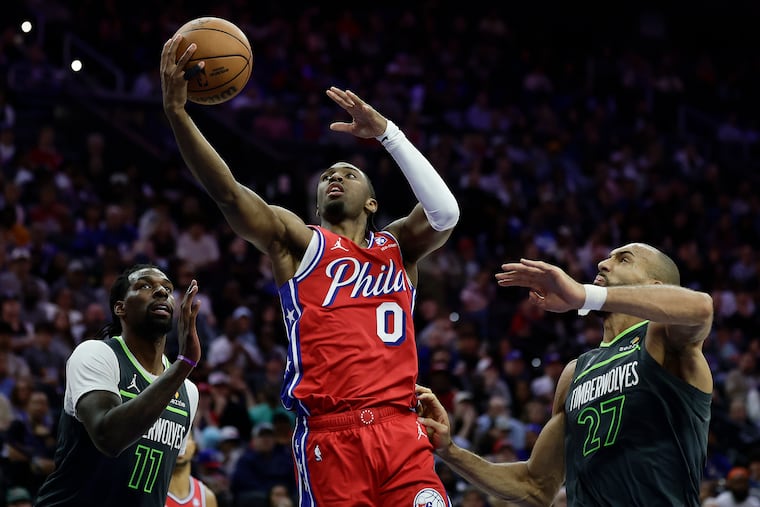 Sixers guard Tyrese Maxey drives to the basket against Minnesota Timberwolves forward Naz Reid (left) and center Rudy Gobert earlier this week.