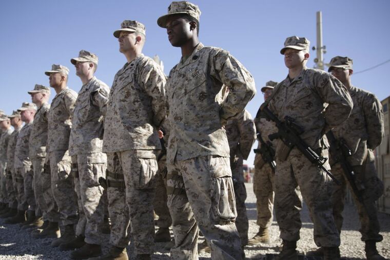 U.S. Marines watch during the change of command ceremony at Task Force Southwest military field in Shorab military camp of Helmand province, Afghanistan.