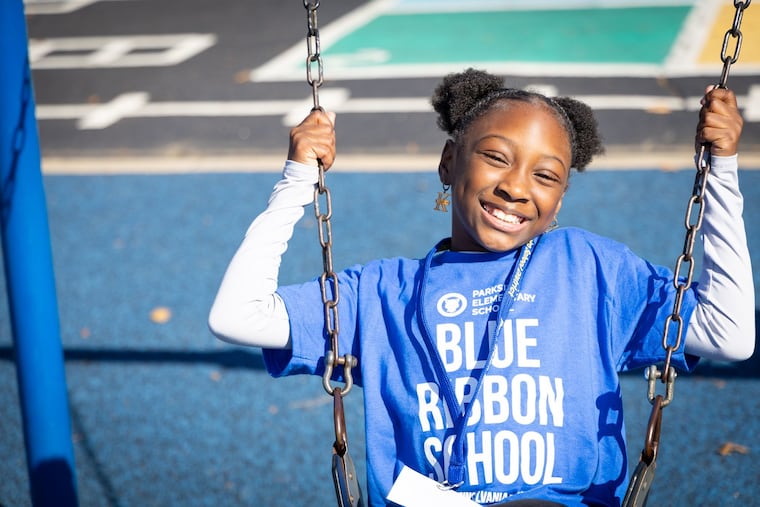 A Parkside Elementary School student celebrates her school's Pennsylvania Blue Ribbon award. The school is in the Penn-Delco School District.