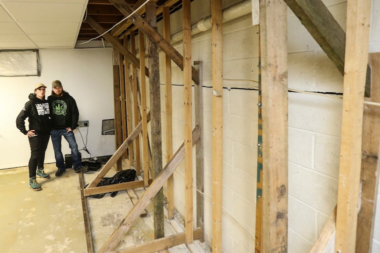 Brooke and Glen Henderson in their basement with a large crack in the foundation. During Ida, the Henderson's septic tank overflowed into the basement and ruined Brooke's just-harvested hemp crop that was drying there and personal belongings as well as damaging the house foundation. They are still fighting the insurer.