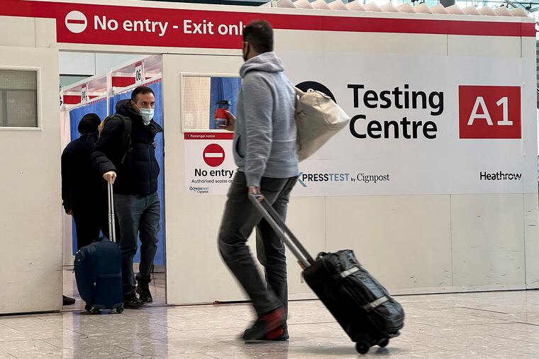 Passengers get a COVID-19 test at Heathrow Airport in London in 2021.