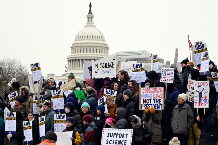 Medical researchers from universities and the National Institutes of Health rally near the Health and Human Services headquarters to protest federal budget cuts Wednesday, Feb. 19, 2025, in Washington. (AP Photo/John McDonnell, File)