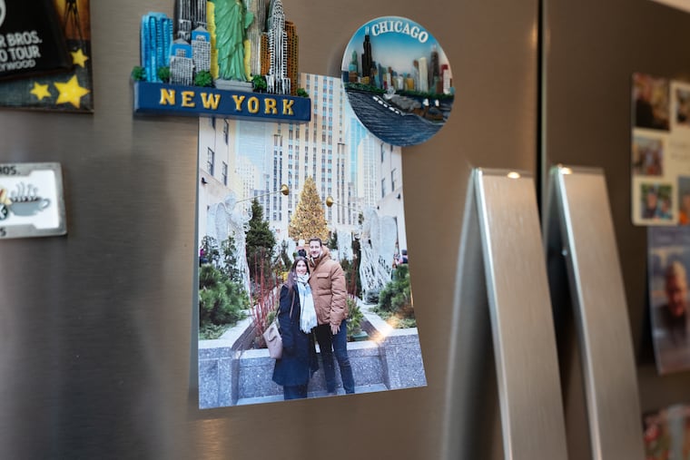 A photograph of Steven Melchiorre and his partner, Iliana Noeli Lick, hangs on the refrigerator in their home in the Point Breeze neighborhood of Philadelphia. Lick, an Argentine citizen, was detained by ICE in July while preparing to board a flight at Philadelphia International Airport.