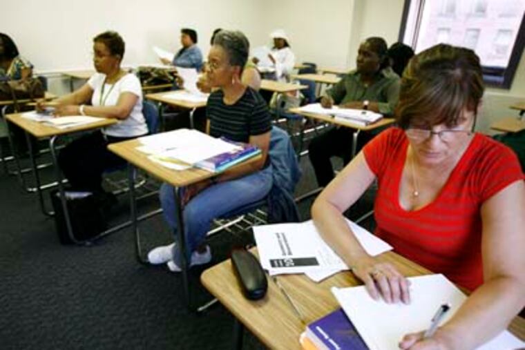 Cookie Yocum (far right) and other city employees in a math class, part of Mayor Nutter's goal to improve the city's college graduation rate. (Eric Mencher/Staff Photographer)