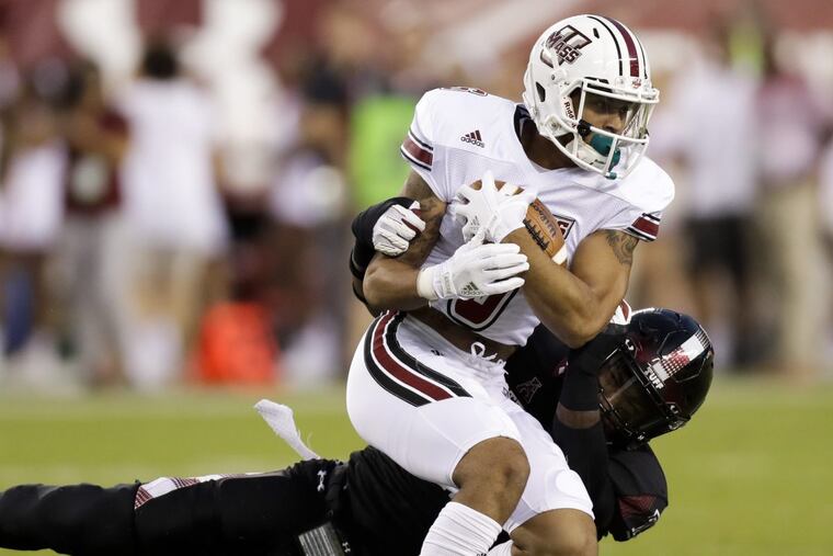 Temple linebacker Chapelle Russell stops UMass wide receiver Sadiq Palmer on Friday, September 15, 2017 in Philadelphia. YONG KIM / Staff Photographer