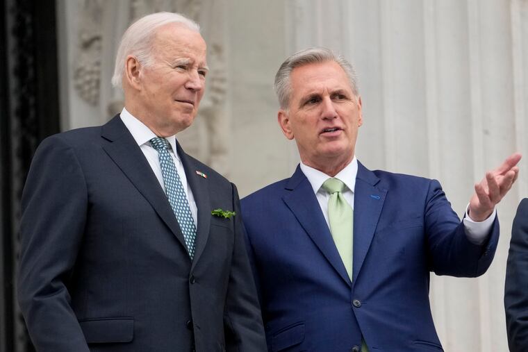 President Joe Biden talks with House Speaker Kevin McCarthy of Calif., on the House steps as they leave after attending an annual St. Patrick's Day luncheon gathering at the Capitol in Washington, in March.