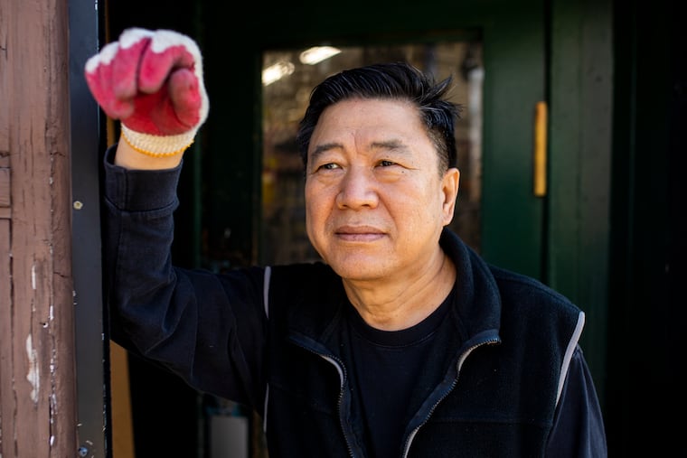 Justin Lee, 65, owner of Fern Rock Hardware, poses for a portrait outside his shop in Philadelphia, Pa., on Wednesday, Dec. 1, 2021.