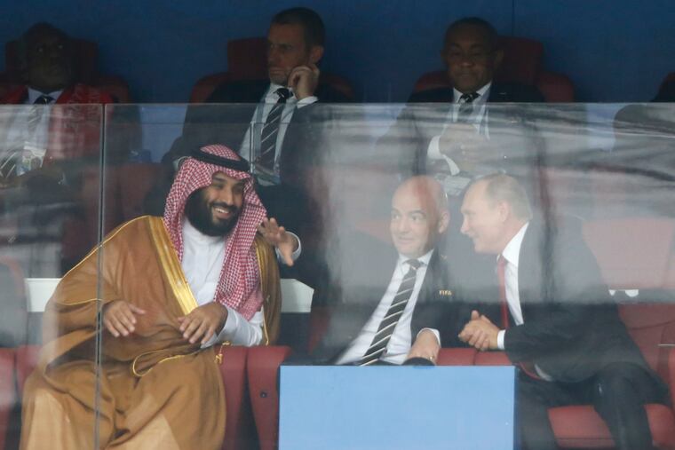 Saudi Arabia Crown Prince Mohammed bin Salman (left), FIFA President Gianni Infantino (center), and Russian President Vladimir Putin watch the match between Russia and Saudi Arabia at the start of the 2018 World Cup in Moscow.