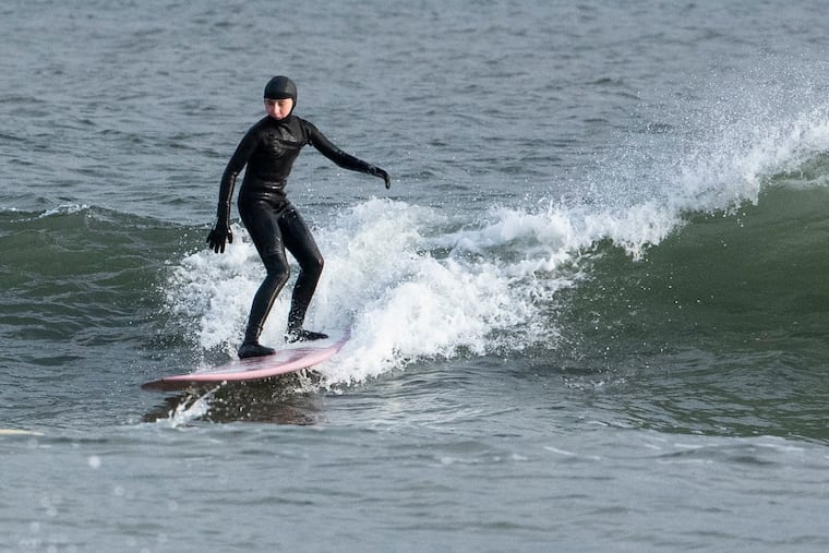 Maeve Smith, 13, surfs at the beach at Willard Avenue in Strathmere, N.J. on Jan. 27.