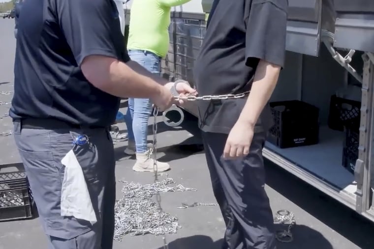 This image from video provided by U.S. Immigration and Customs Enforcement shows a person being handcuffed at the Hyundai-LG plant, Thursday, Sept. 4, 2025, in Ellabell, Ga.