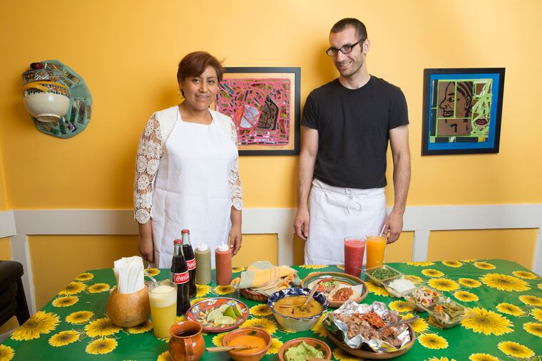 Cristina Martinez, left, and Ben Miller, right, photographed at South Philly Barbacoa, Friday, Sept. 16, 2016, in Philadelphia. On the table are two tacos, a bowl of consommé, and a half kilo of lamb. As well as fresh squeezed juices.