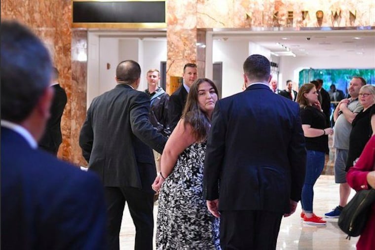 Melissa Byrne being escorted at Trump Tower. She said two neighbors reported being questioned by Secret Service agents. No one from the agency has contacted her, she said.