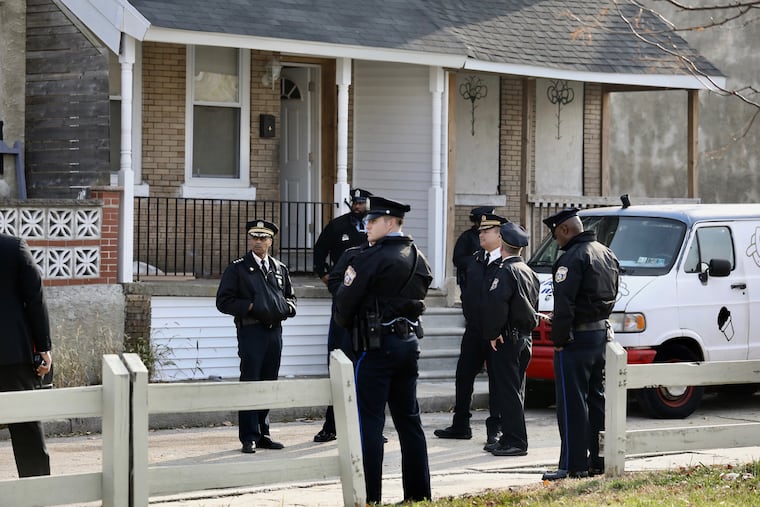 Philadelphia police outside row house on 5100 block of Malcolm in West Philadelphia site of a multiple homicide on Monday afternoon, Nov. 19, 2018.