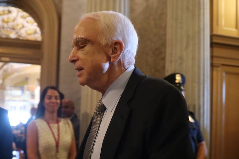 With a scar from surgery still visible on his face, John McCain arrives at Capitol Hill to vote in favor of a measure in the process to abolish Obamacare.