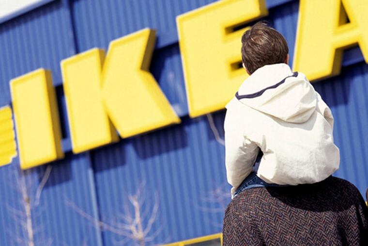 An unidentified family is seen in front of an IKEA furniture market on an undated file photo. (AP Photo/Inter IKEA Systems B.V.)