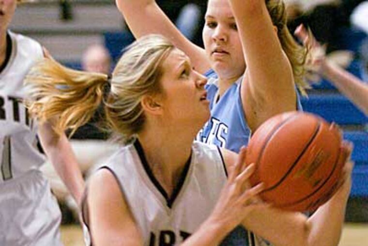C R North's Dana Storjohan puts it up despite defense from Boone's Erin Hughes. (Ron Tarver / Staff Photographer)
