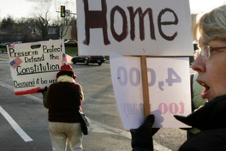 Annabel Grote of Rydal (right) and Mavra Lano of Wyncote protest the Iraq war at an intersection in Elkins Park.