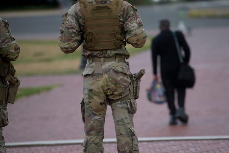 Armed National Guard members are positioned outside of Union Station in Washington, D.C., on Sunday, Aug. 24, 2025.