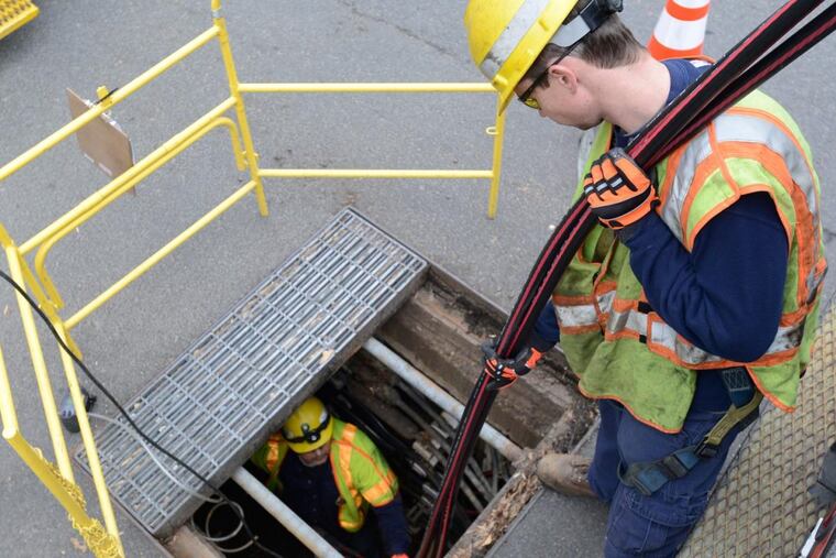 Utility workers install underground power lines to Pepco utility, which serves Washington, D.C, and parts of Maryland. The utility is embarking on a six-year $500 million effort called DC Power Line Undergrounding (DC PLUG) to bury some of the more vulnerable aerial power lines in the capital.