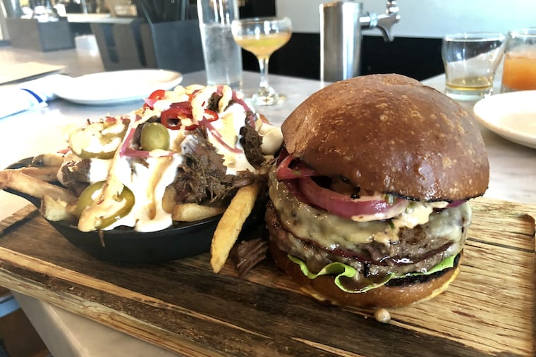 The burger at the Ripplewood in Ardmore is a double-stack of juicy patties layered with Lebanon bologna, Gouda cheese and special sauce.