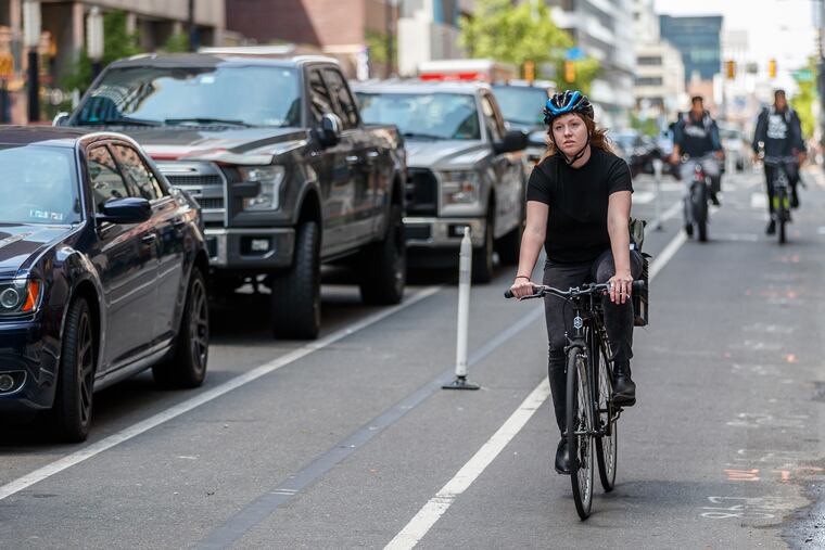 A "parking-protected" bike lane on Market Street in Philadelphia. A line of parked cars protects cyclists from street traffic.