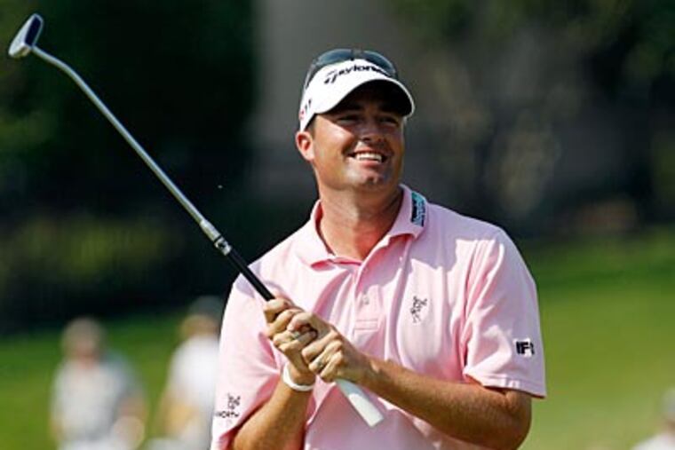 Ryan Palmer smiles after his putt on the 18th hole during the third round of the Byron Nelson Championship. (LM Otero/AP Photo)