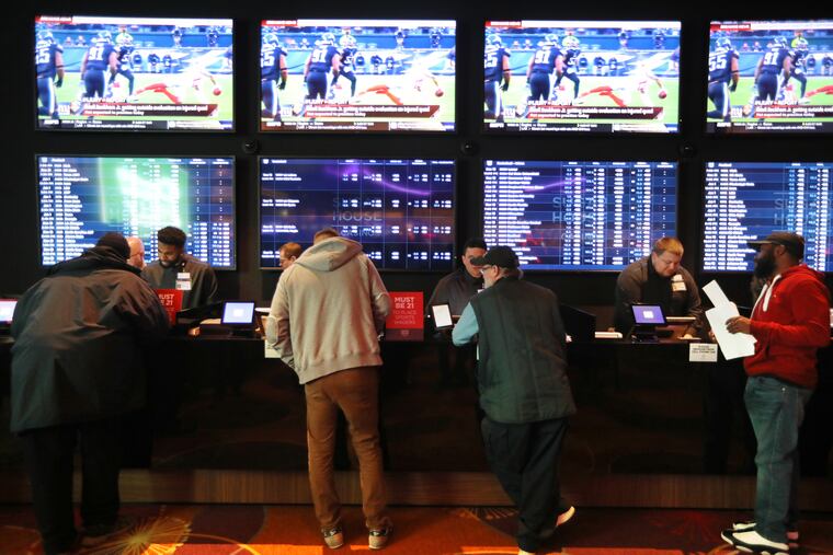 Bettors af the SugarHouse Casino sportsbook on launch day, Dec. 13. DAVID SWANSON / Staff Photographer .
