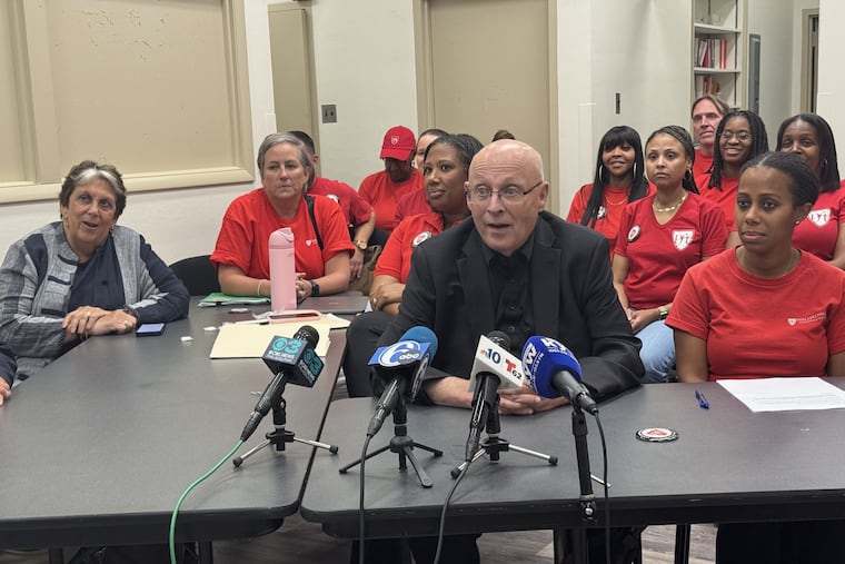 PFT president Arthur Steinberg (in black) and chief of staff LeShawna Coleman (to his right) discuss the union's contract, ratified by members Thursday night.