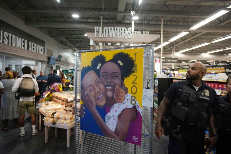 A painting titled "Hope" by Senia Che is on display as dignitaries and members of the media take a tour of the newly renovated Tops Friendly Markets on Jefferson Avenue in Buffalo, N.Y., which reopens tomorrow, two months after the racist attack, Thursday, July 14, 2022.