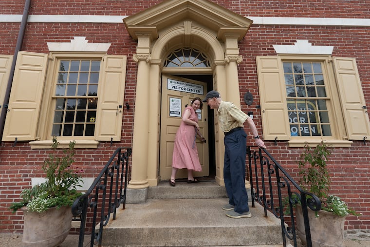 Kaila Temple, curator, opens the front door for Irvin Miller, at the new Germantown visitor center at the Germantown Historical Society building.
