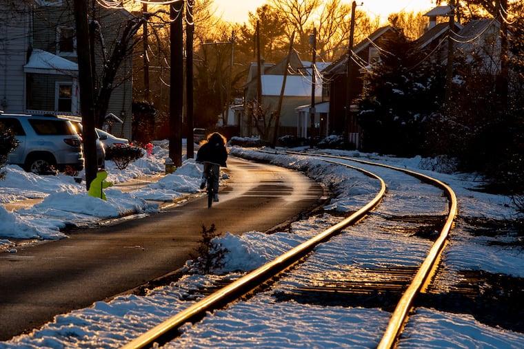 The sun sets upon streets in Moorestown on Monday. Tuesday the region could get a dusting, but forecasters are calling for the possibility of more 'plowable snow' Wednesday night into Thursday, with more on Friday.