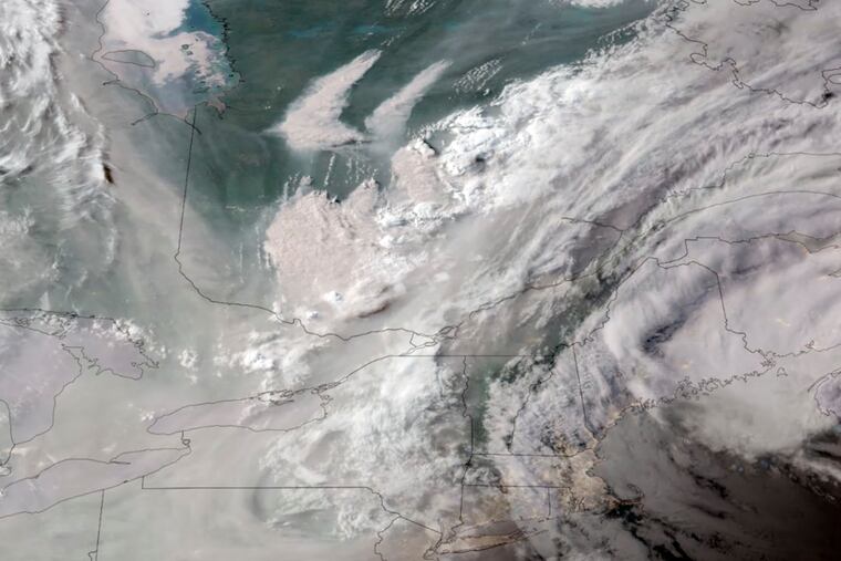 In this GeoColor satellite image taken Monday and provided by CIRA/NOAA, smoke from wildfires burning in Quebec, Canada, top center, drifts southward.