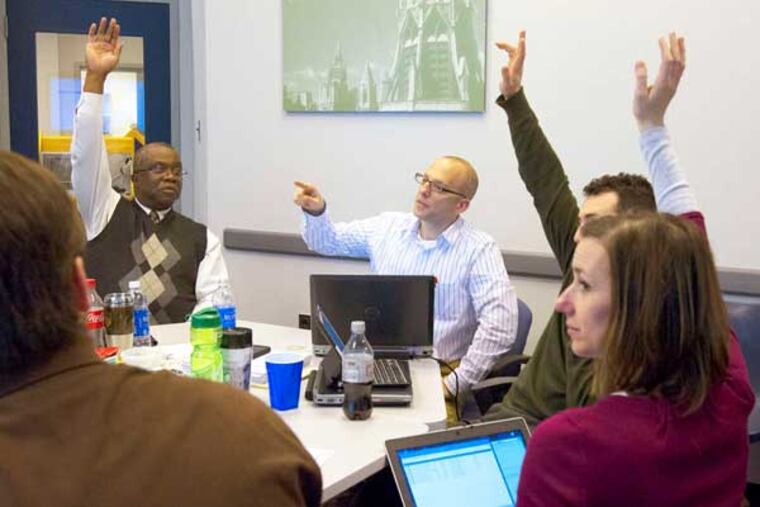 Bruce Bunnick (center), director of admissions at Lehigh University, counts the votes of the admission committee as it decides on a student's application. (Ed Hille / Staff Photographer)