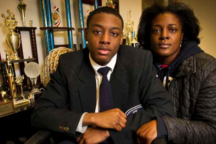 Darrin Manning a student at Math Civics Science Charter school at 447 N. Broad St. in Philadelphia. He was hurt during an arrest by Philadelphia police. Photograph with his mother Ikea Coney at the school on Monday, January 13, 2014. ( ALEJANDRO A. ALVAREZ / STAFF PHOTOGRAPHER )