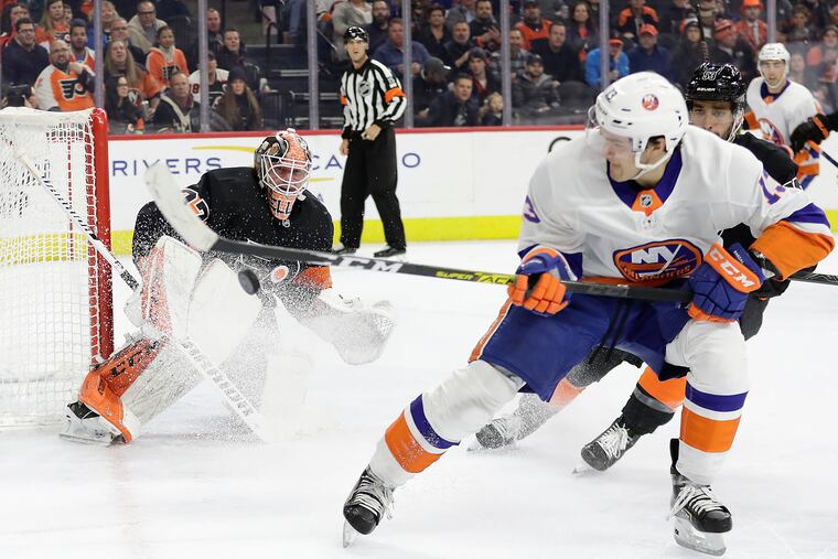 Flyers goaltender Brian Elliott gets in position to stop the Islanders' Mathew Barzal during Saturday's game at the Wells Fargo Center.