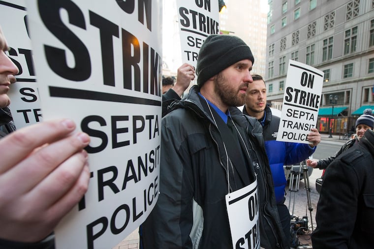 Striking SEPTA Transit Police Officers stand outside of SEPTA Headquarters at 1234 Market St. on March 6, 2019.