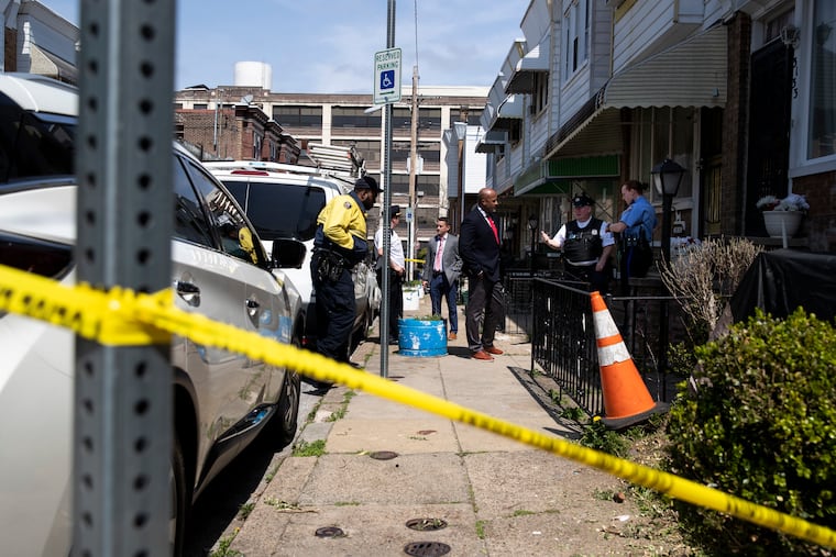 Officers gather outside of a home on North Patton Street where a child was shot on Wednesday.